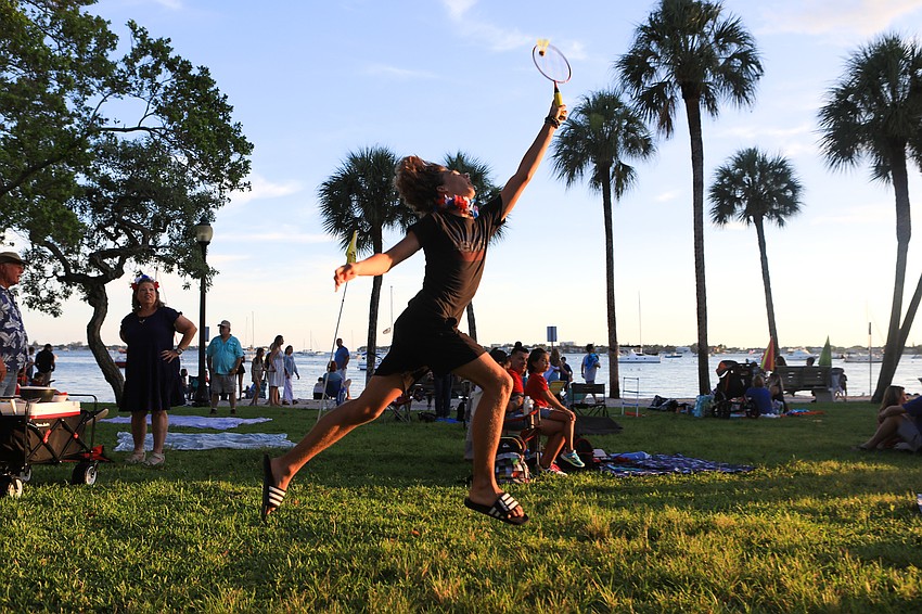 Yan Alex Ivanov leaps high to play badminton.