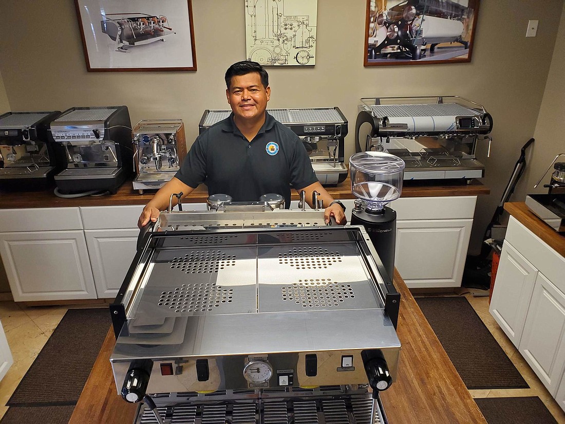 Jose Parada in his espresso machine showroom at 3653 Regent Blvd., Suite 203, in East Park Business Park. He is preparing to open a shop and showroom this fall in St. Johns Town Center North. (Photo by Drew Dixon)