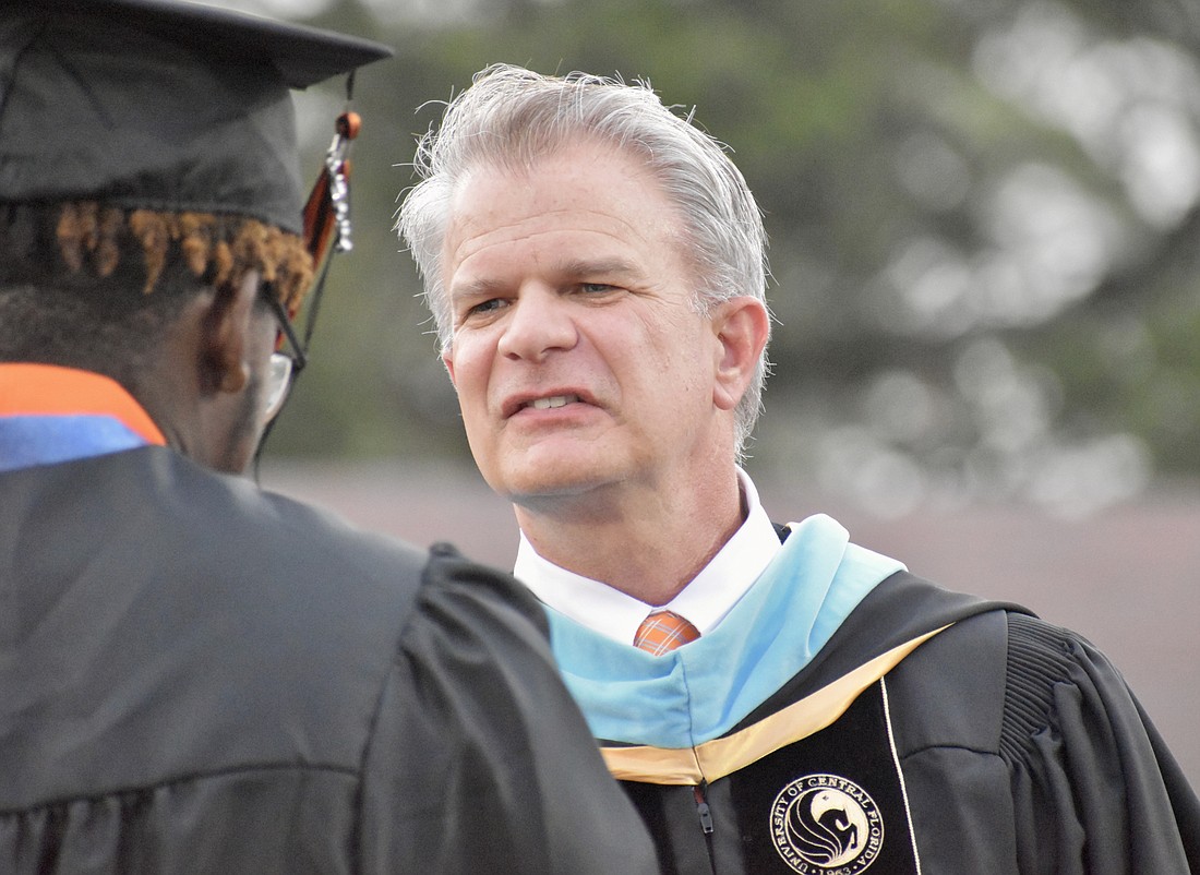 Superintendent Brennan Asplen congratulates a Sarasota High graduate during ceremonies in May.