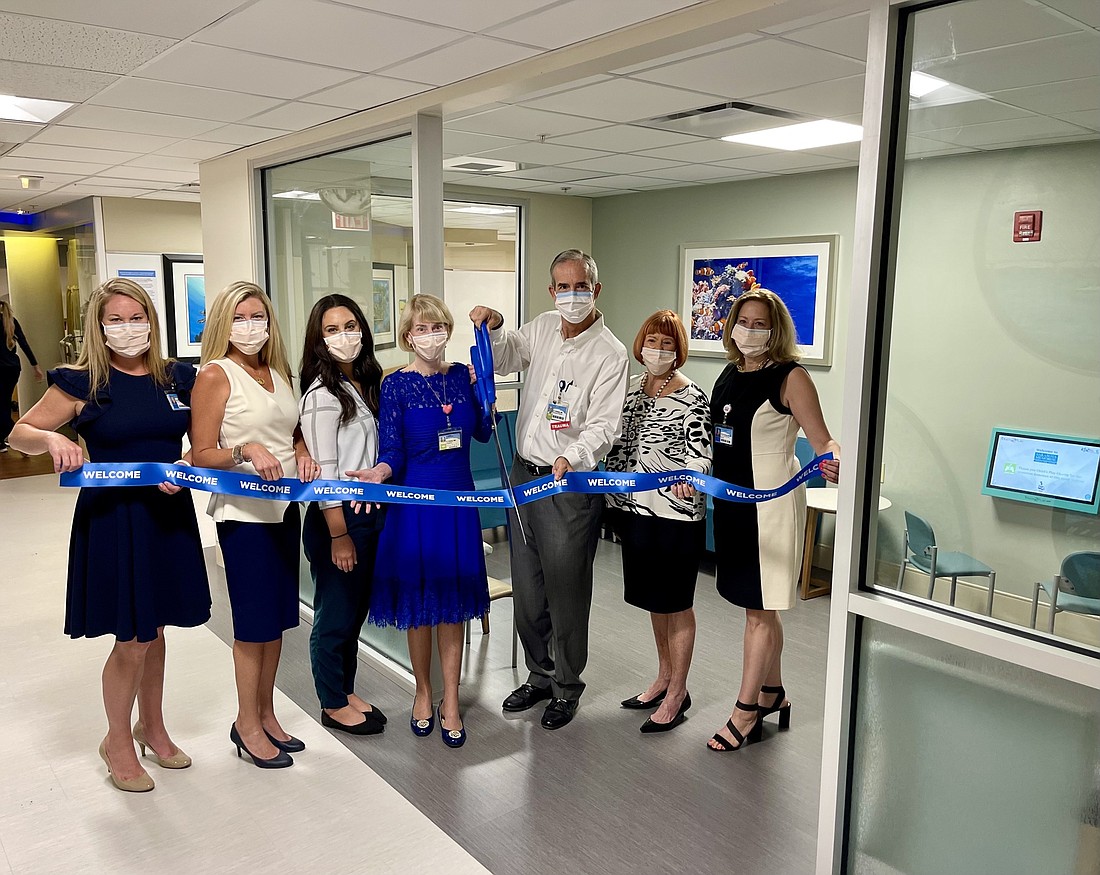 Medical staff and members of the Sarasota County Public Hospital Board open the new waiting area.