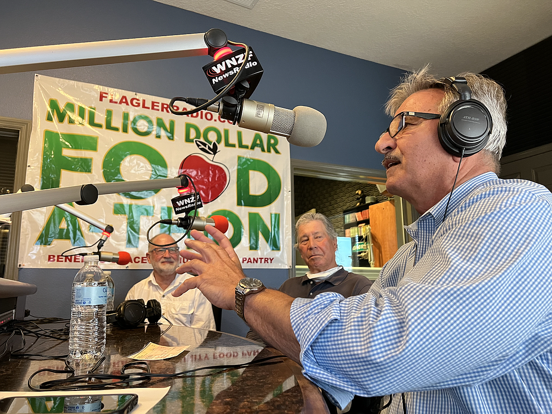 Grace Tabernacle Ministries Pastor Charles Silano, the founder of the Grace Community Food Pantry, speaks on the air during the Food-A-Thon. Photo by Brian McMillan