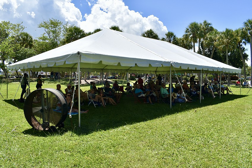 A tent and fan help keep the crowd cool.