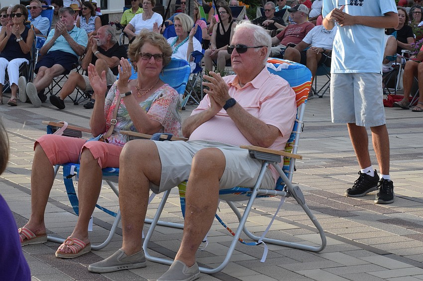 Del Webb's Laurel and John Platt stomp and clap along during the performance of Queen's 