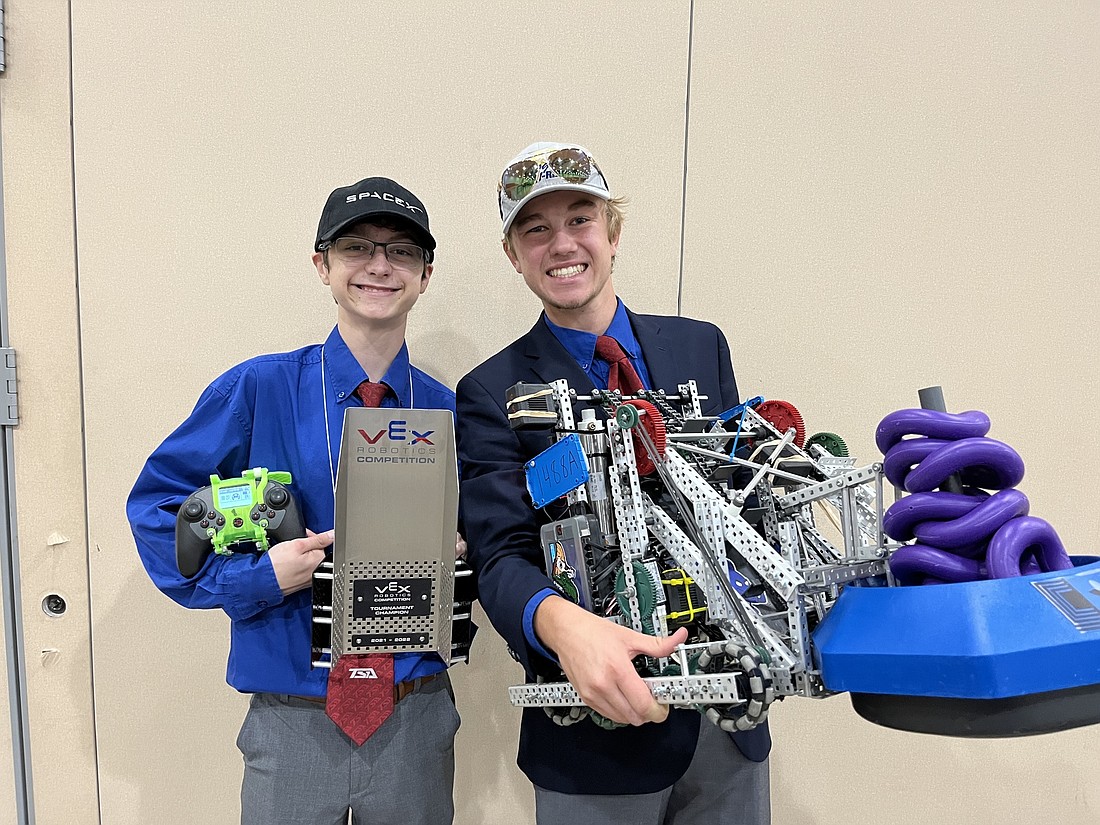 Austin Bruce holds the award and Zachary Geiger holds the robot they built to win the VEX Robotics Competition at the National TSA Conference in Texas. (Courtesy photo)