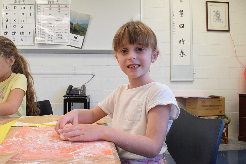 Dolly Rees, who is 6, loves kneading her dough. 