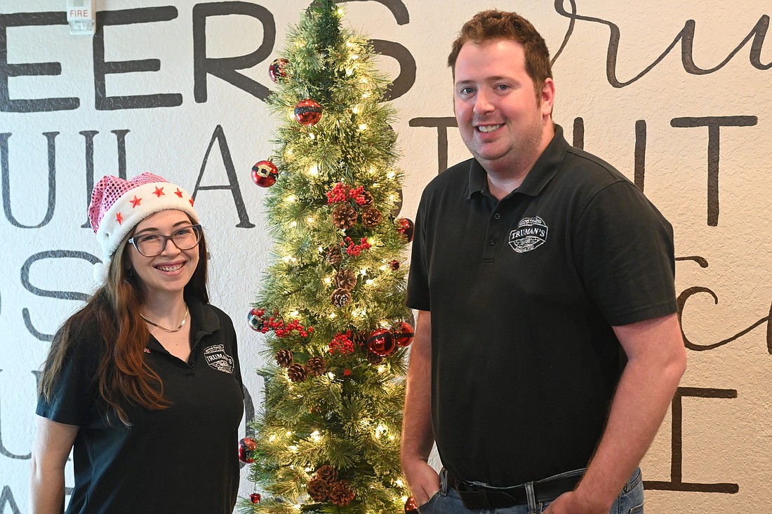 Maggie Harrington and Justin Simms are helping Truman&#39;s Tap & Grill get into the holiday spirit a little early. (Photo by Spencer Fordin)