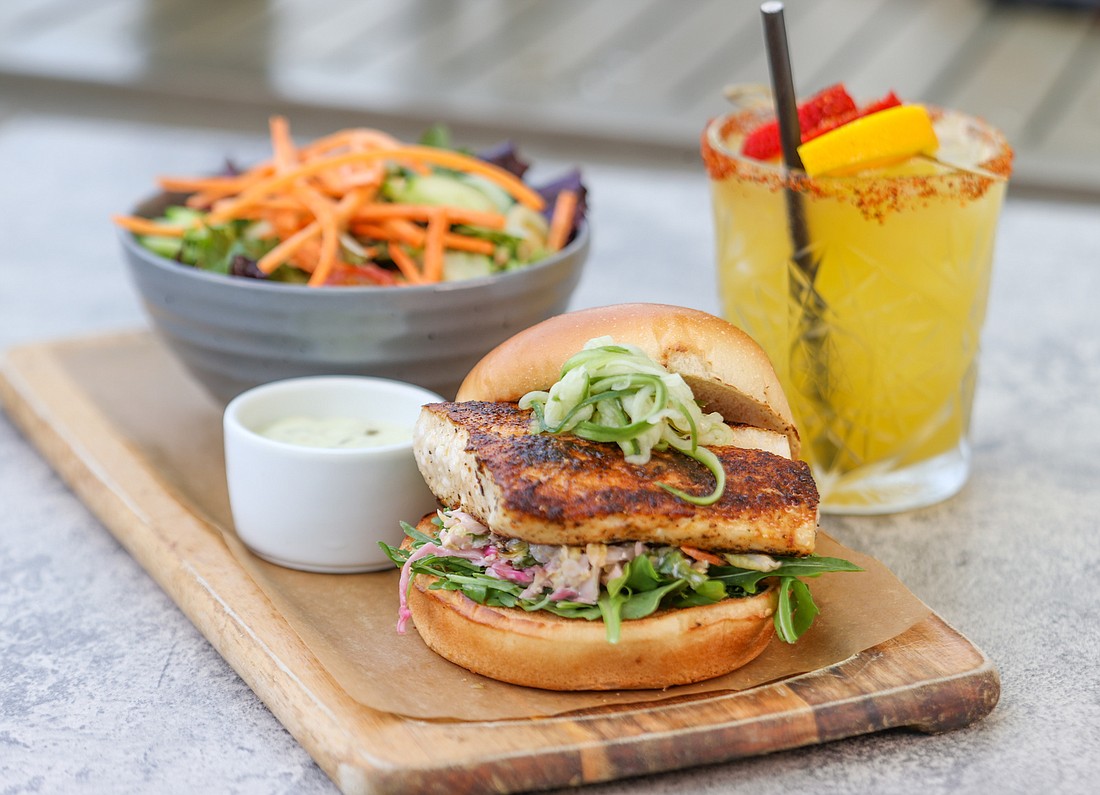 The grilled fish sandwich at Lake Park Diner features local fresh fish, pickled julienned cucumber, organic baby arugula, cilantro-lime slaw, and champagne-tartar sauce, on a brioche bun. (Courtesy photo)