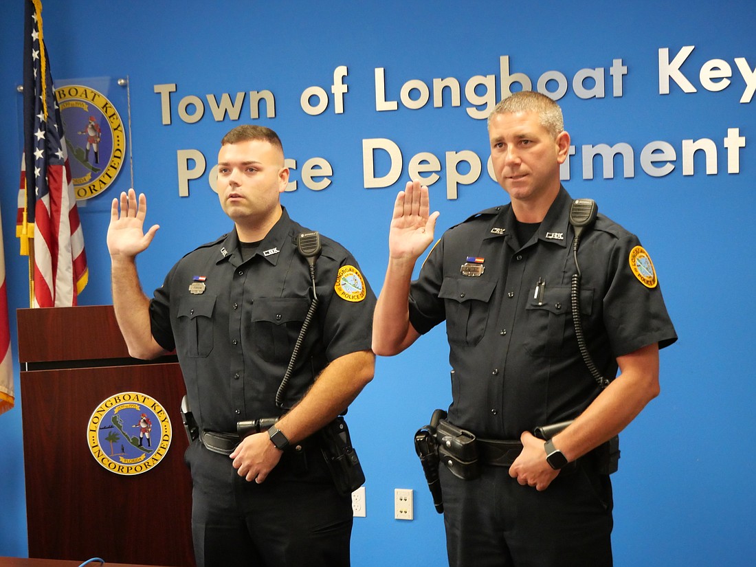 Joseph Ferrigine and Kevin Smith take their oath as they are sworn in. (Courtesy photo)