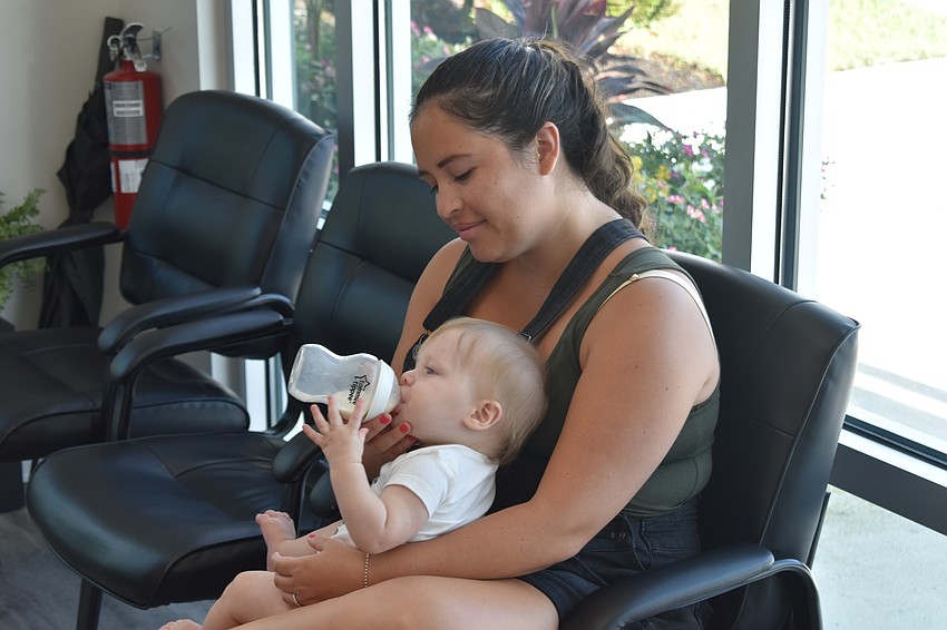 Bradenton's Tina Wilson holds 7-month-old Parker Wilson at the grand opening.