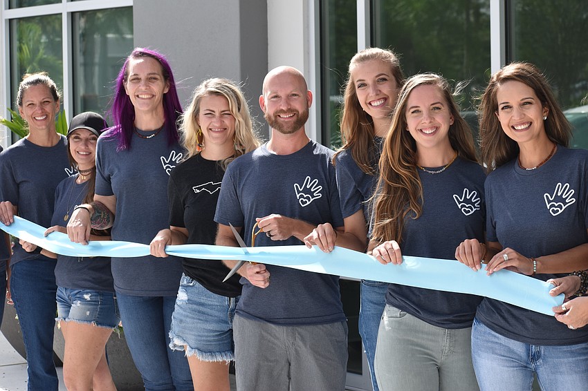 The ribbon cutting takes place.