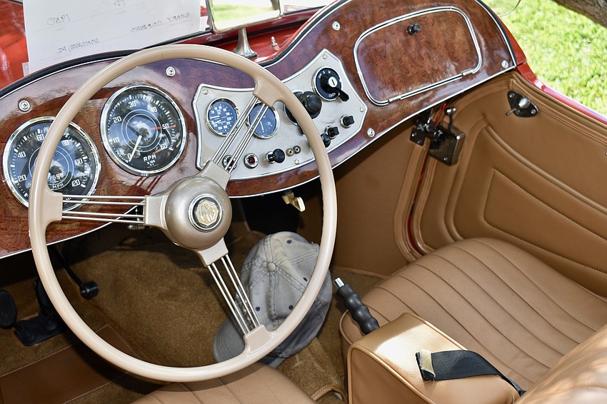 Original and refurbished cars line St. Armands Circle for a car show.