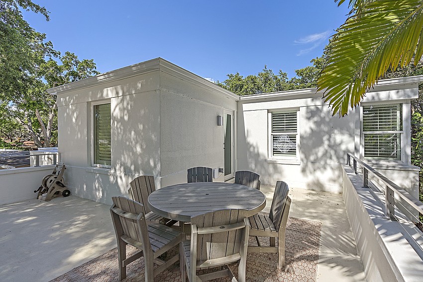 On the upper level, a balcony allows for open air dining.