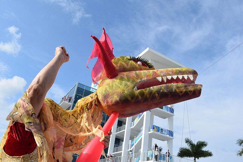 A dragon led the parade of athletes in the shadow of the Nathan Benderson Park finish tower.