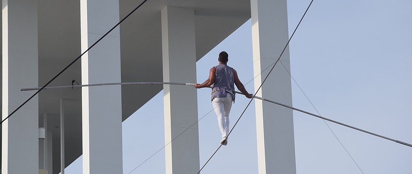 Blake Wallenda  approaches the Nathan Benderson Park finish tower to complete his daredevil stunt during the opening ceremony.
