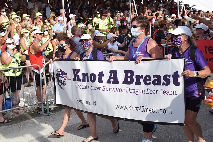 Breast survivor category teams are represented in the parade of athletes.