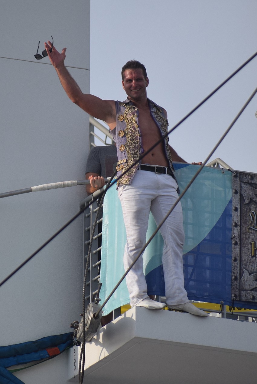 Blake Wallenda waves to the crowd after he completes his daredevil skywalk.