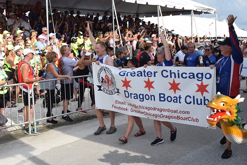 Chicago paddlers react to the crowd during the parade of athletes.