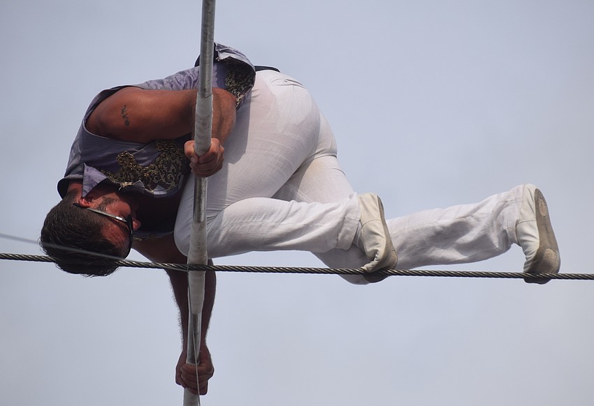 Blake Wallenda pauses in the middle of his skywalk to the finish tower to perform a stunt high above the crowd at Nathan Benderson Park.