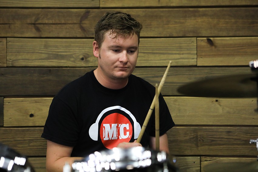 Music Compound instructor Ben Tilford provides backups on the drums.