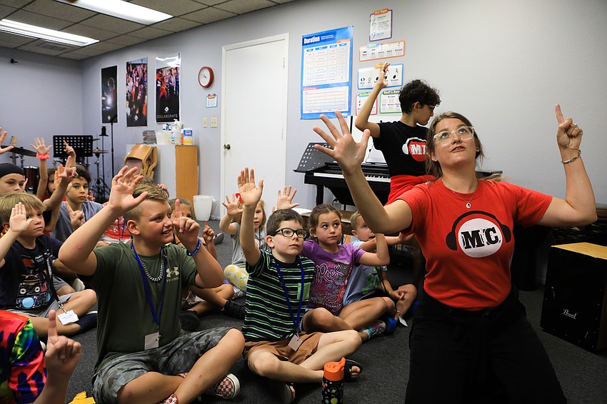 Instructors Sophia Derias and Julia Tilford get the students to think about their finger placement when playing.