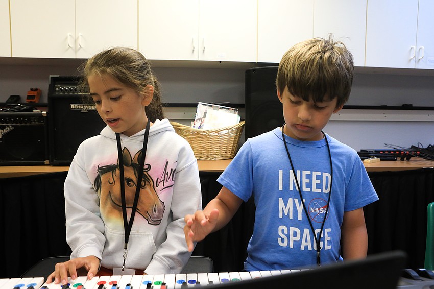 Ava Valdivieso and Max Fiers-Flath practice their finger placement.