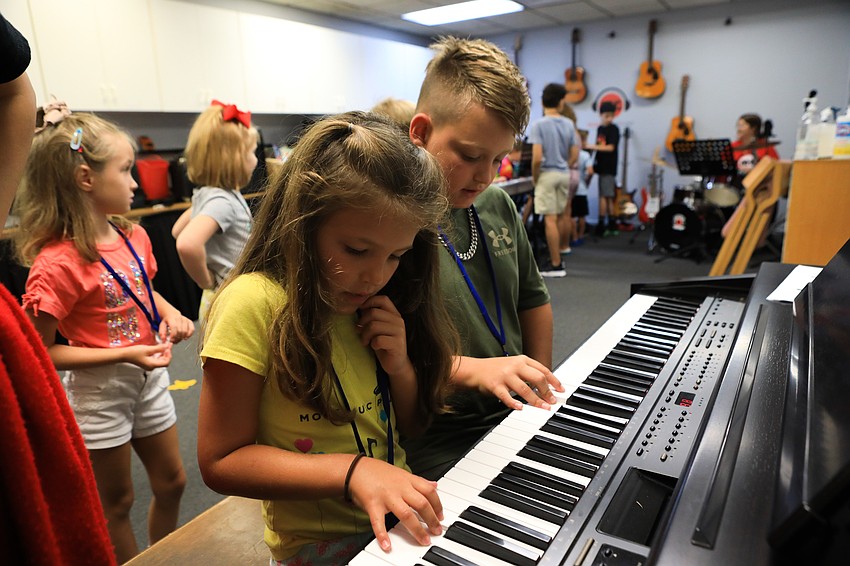 Elia Cianfaglione and Levi Zipperer work with instructor Sophia Derias on making music.