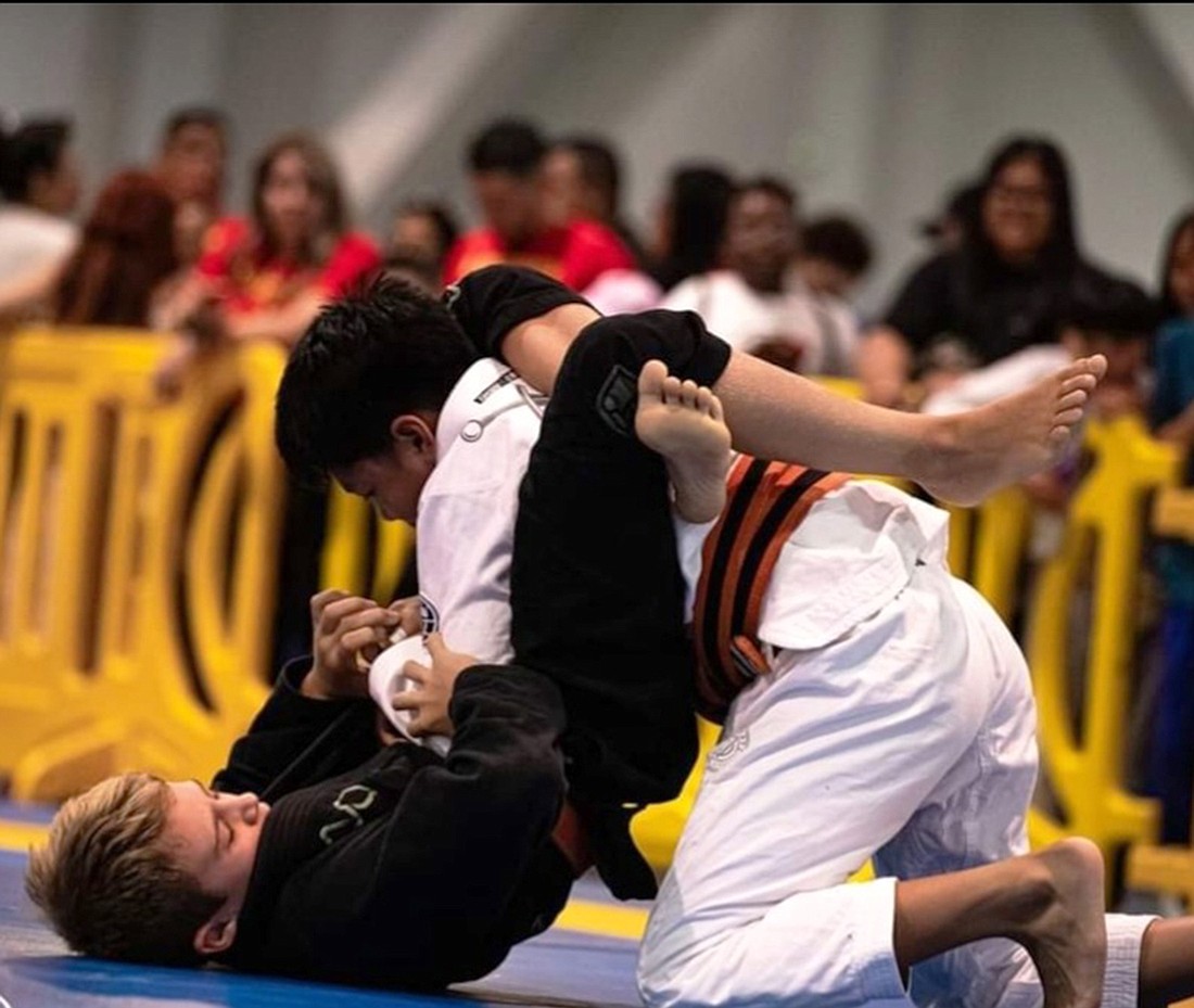 Sarasota Brazilian jiujitsu athlete Taber Jordan puts a triangle hold on Sebastian King Acero  during the American National Kids IBJJF Jiu-Jitsu Championship. Photo courtesy Jocelyn Jordan.