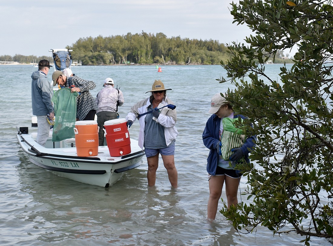 Susan Cranwell and Calynn Stewart come ashore during this year&#39;s clean-up. (File photo)