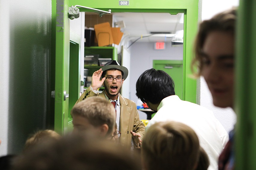 Diego Morales as Detective Monty Jack keeps the students at bay to avoid seeing the body.