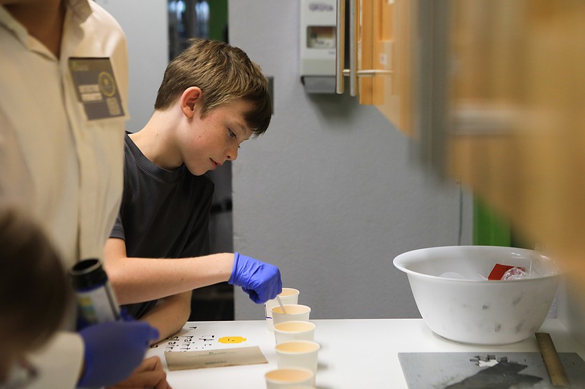Peter Calvin checks pH levels in a lab room.
