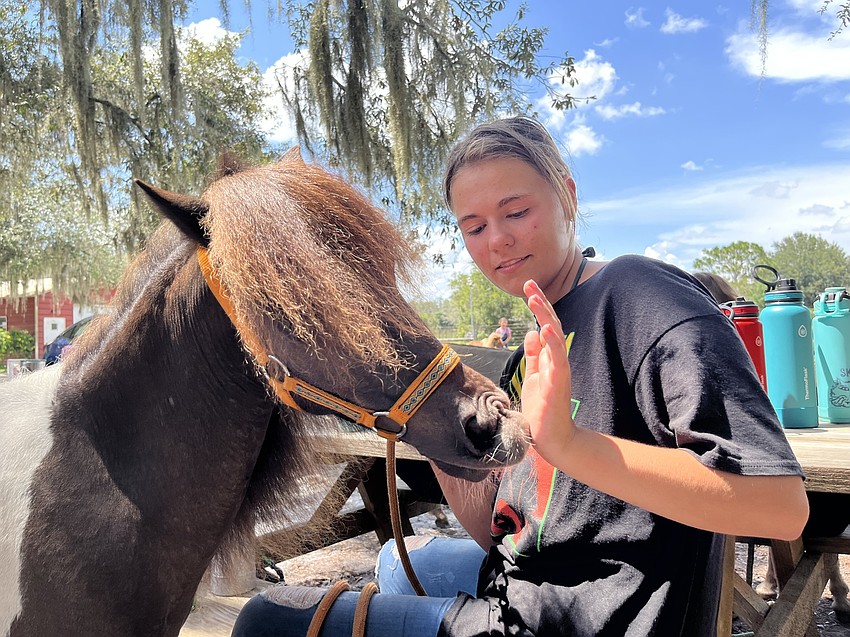 Rowdy licks camp counselor Jessica Davis' hand. 