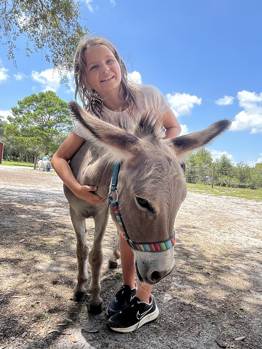 Kaelyn Zabikow, who is 8, loves working with Bruiser, a donkey.