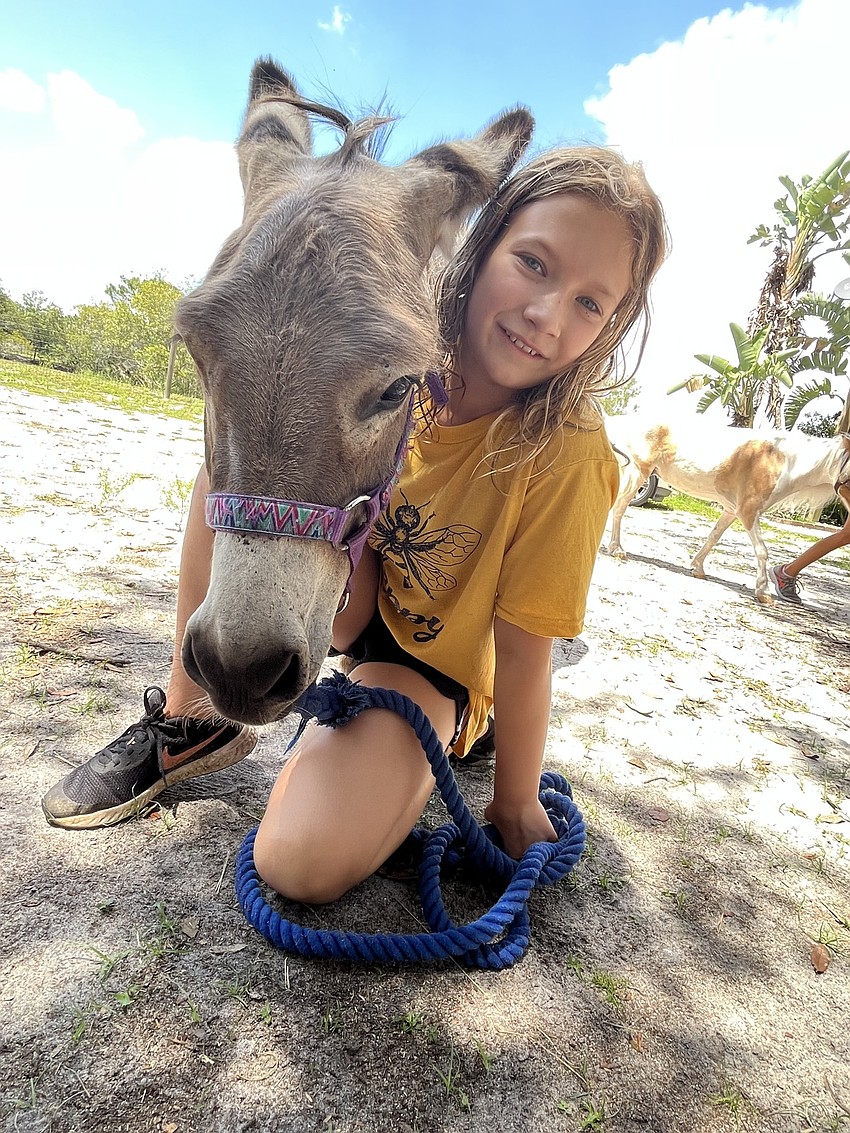 Skye Baldock, who is 10 years old, works with a donkey, Monster. Baldock has participated in the camp for the past three years.