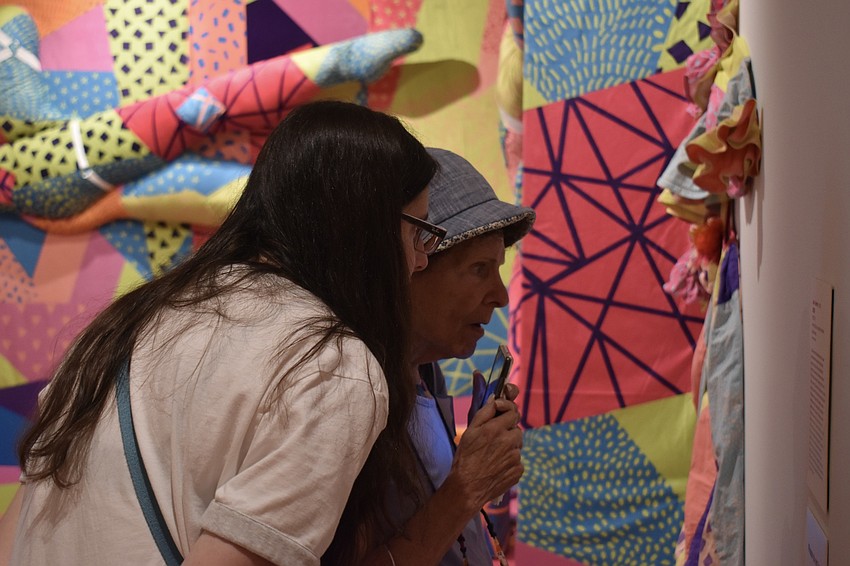 Marla Sax and Barbara Pressman read about the art installation.