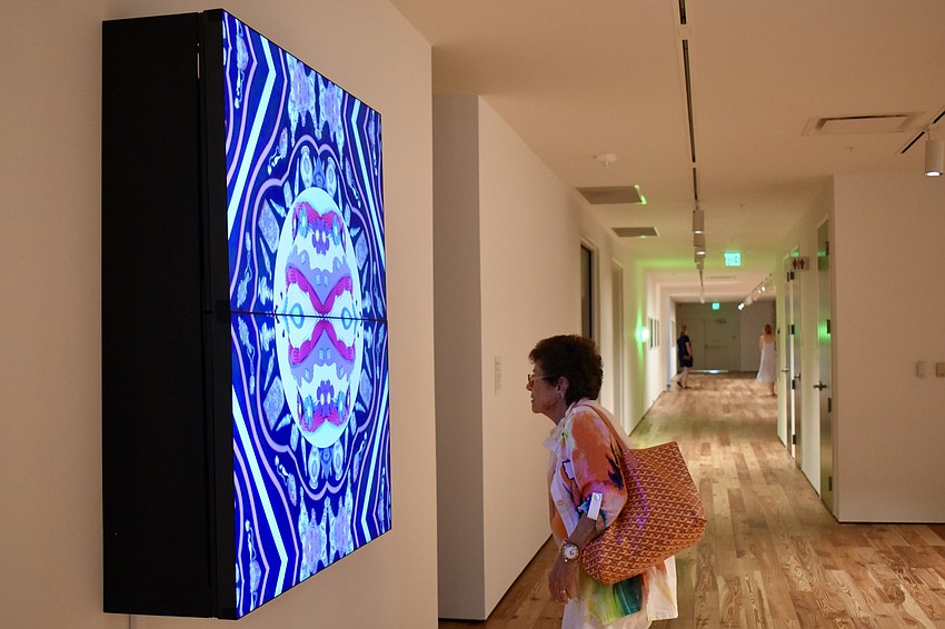 Carol Edleman reads about a digital display of art.