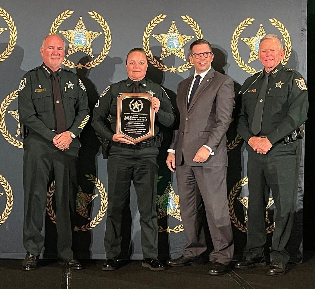 Law Enforcement Officer of the Year Deputy Crista Rainey. From left to right: Sheriff Staly, Crista Rainey, Award Sponsor Edwin Narain of AT&T and FSA President Bobby McCallum. Photo courtesy of the FCSO