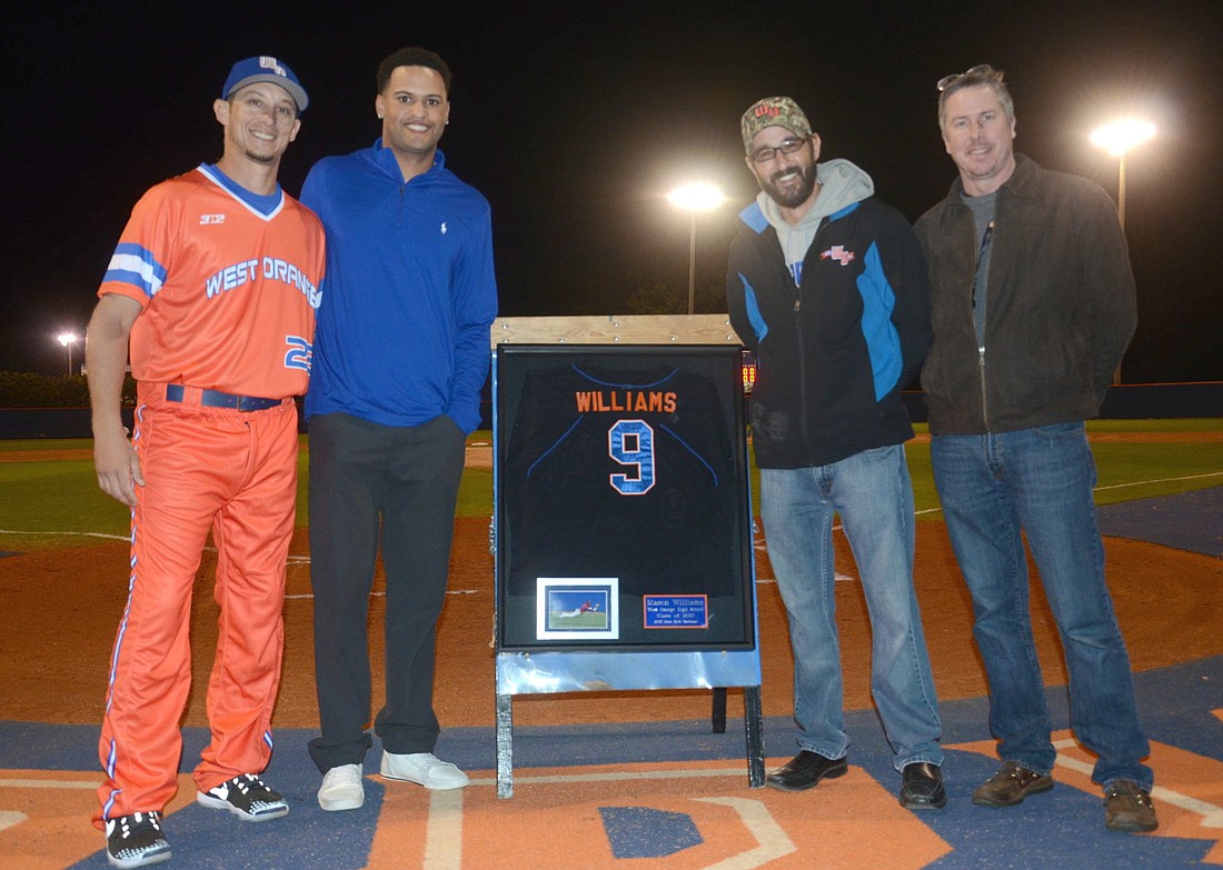 Mason Wiliams, second from left, was joined by West Orange coach Jesse Marlo, principal Doug Szcinski and Orange County Public Schools' James Larsen on the night his number was retired.