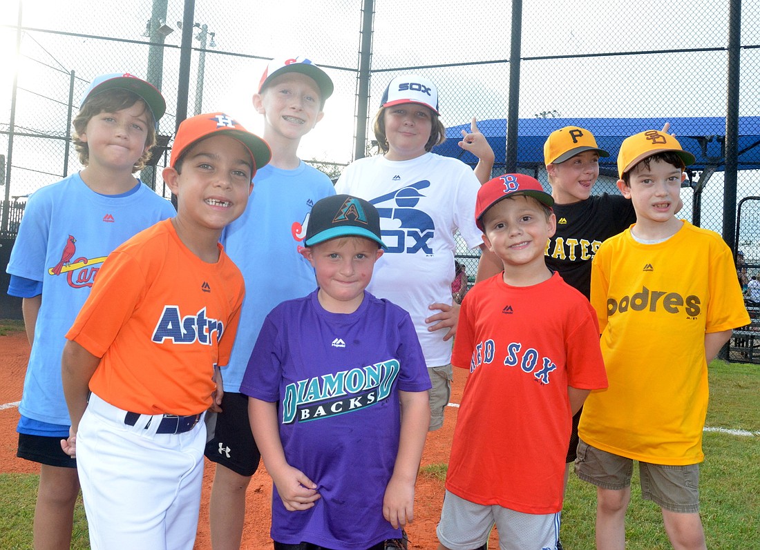 Alex Doggett, left, Lucas Wannuck, Carson Goodman, Logan Myers, Carson McMilan, Elijah Neff, Breven Walker and Logan Wetmore are all smiles in their throwback uniforms.