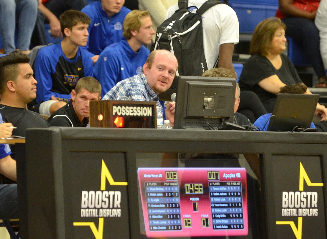 Mark Bartschi, center, does play-by-play and public address duty â€” while keeping stats â€” of the Apopka versus Winter Haven game of the Metro vs. Florida Challenge Nov. 26.