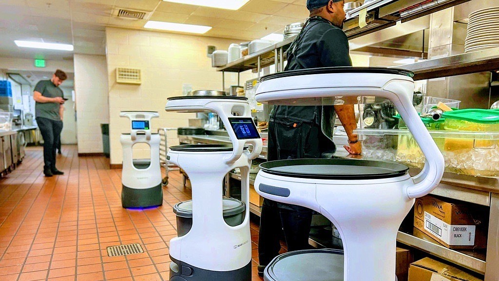 Three Servi robots help deliver food and bus tables at Cypress Cove. (Courtesy photo)