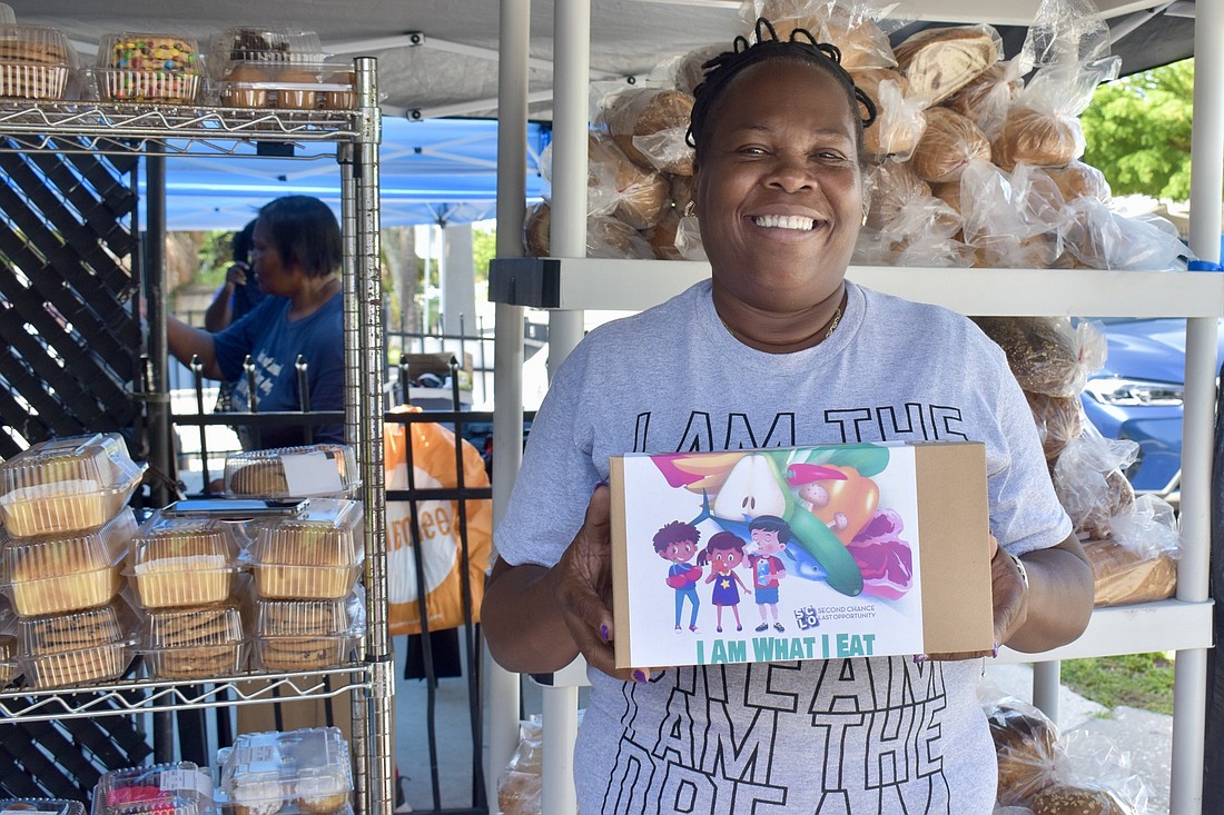 April Glasco holds a box of healthy snacks. The boxes are being distributed as part of a new campaign to promote healthy eating, called "I am what I eat." (Photo by Lesley Dwyer)