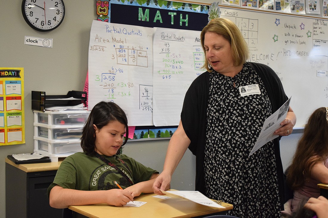 Ethan Conner, a Freedom Elementary School fourth grader, works with Melanie Stern, a Project TEACH volunteer. More Freedom Elementary students will be able to participate in Project TEACH once an addition is built. (File photo)
