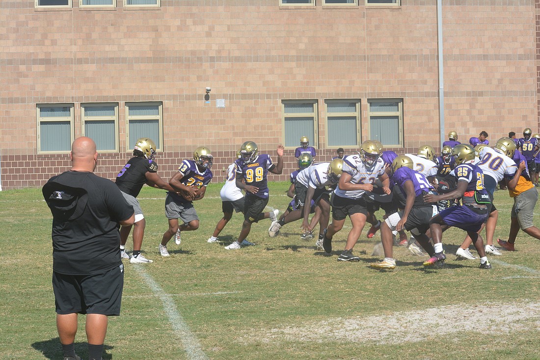 Booker High football Coach Scottie Littles watches his scout team offense at an Aug. 16 practice. (Photo by Ryan Kohn)