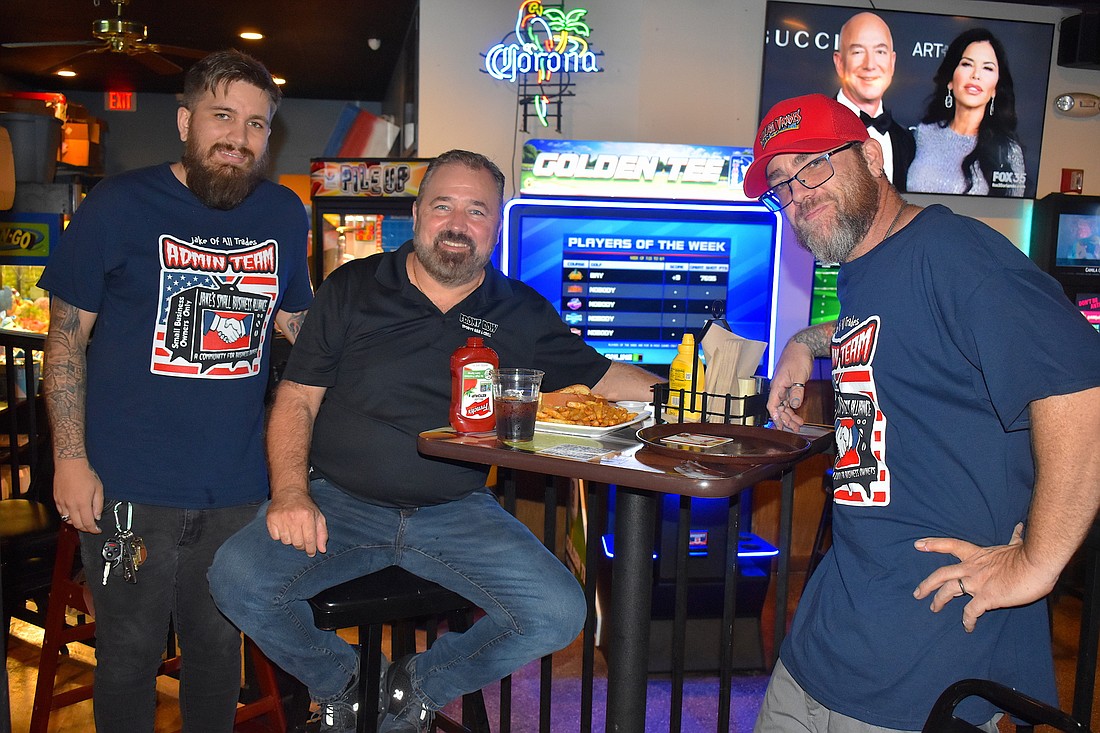 Jordan and Charles Lewis, left, owners of Front Row Sports Bar and Winter Garden Restaurant, with Jake McKenna, right, from Jake of All Trades.