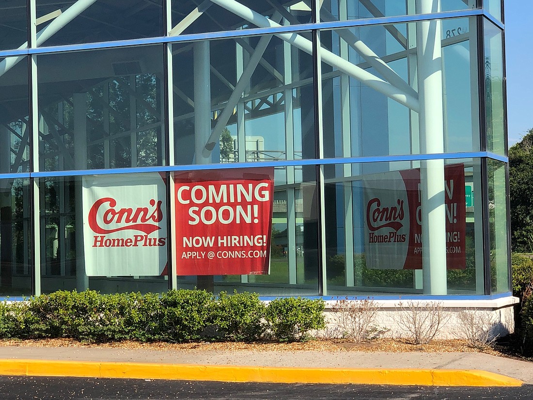 A "coming soon" sign in the window at Connâ€™s HomePlus at 9278 Arlington Expressway in the Regency Court Shopping Center.