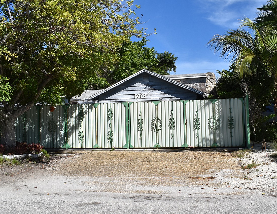 The fenced property at 203 Garfield Drive includes two buildings, both constructed in 1936. (Photo by Eric Garwood)