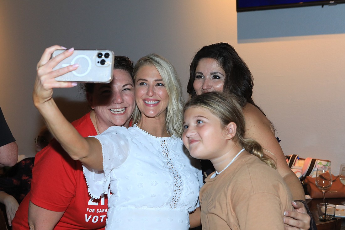 School Board member Bridget Ziegler snaps a selfie with supporters at an election-night celebration Tuesday.