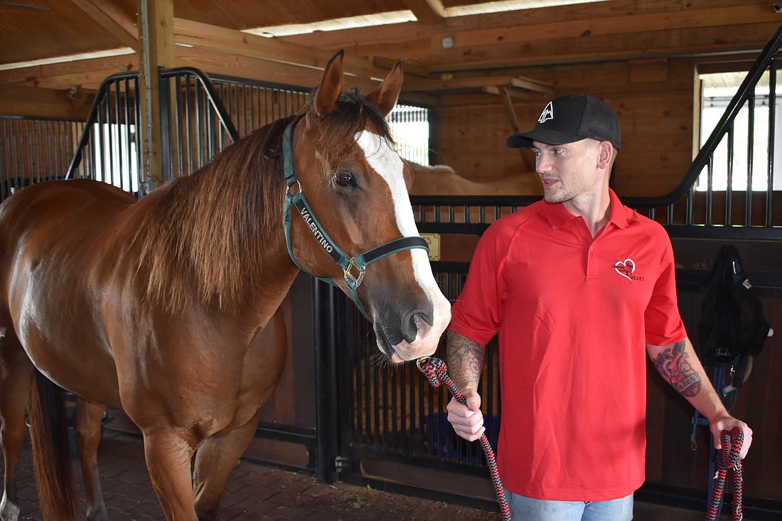 30-year-old Palmetto resident Michael Manuel, pictured with Valentino, participates for help with PTSD, and to learn a new skill. (Photo by Ian Swaby)