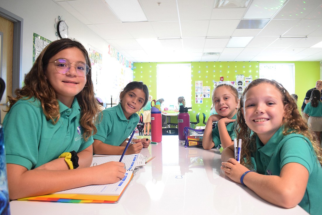 Fourth graders Lelia Rodriguez, Catalina Poole, Emily Topping and Molly Jae work collaboratively on an assignment. Each of them went to a different elementary school before attending Lakewood Ranch Preparatory Academy. (Photo by Liz Ramos)