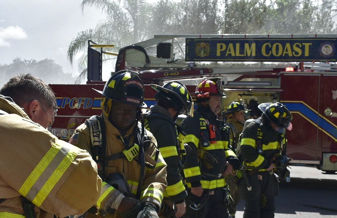 Palm Coast firefighters work together at an incident scene. Image from City Council agenda documentation
